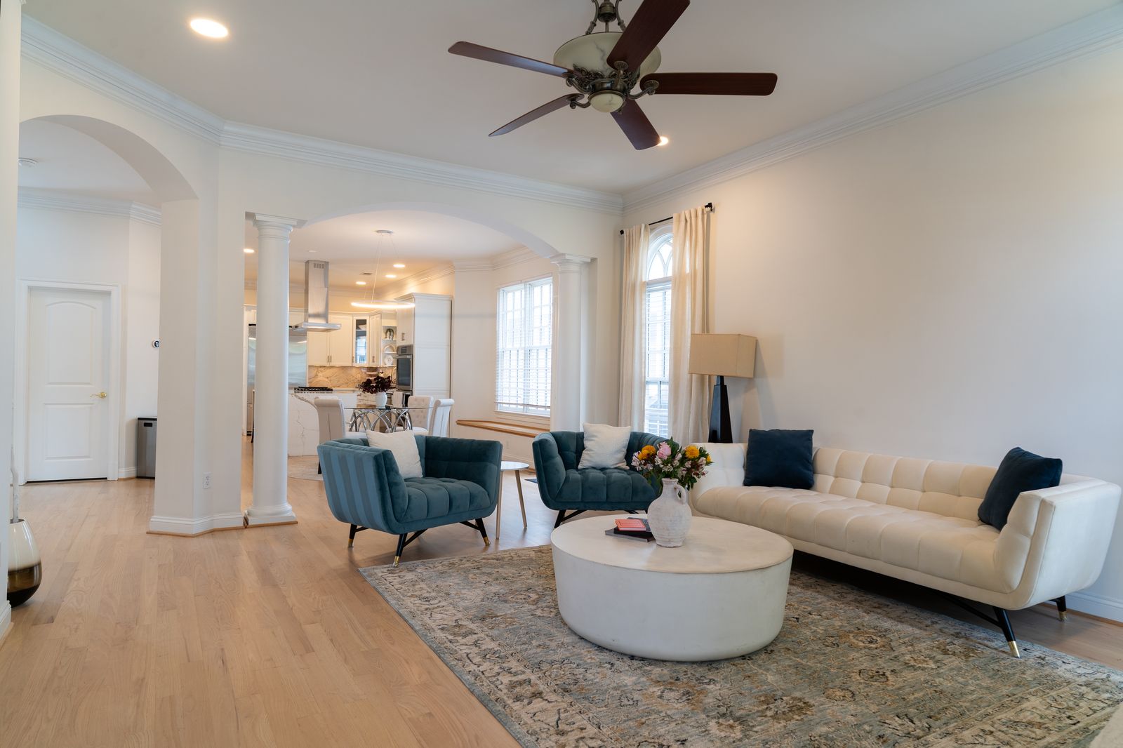 Open plan living area with columns and arched openings